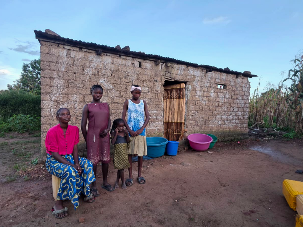 Sylvie and her family outside their home in the Democratic Republic of Congo