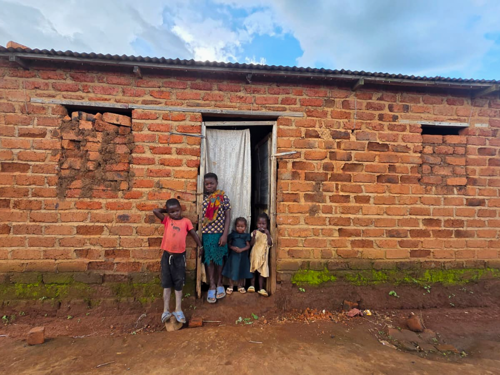 Dorcas and her three younger siblings outside their home in the Democratic Republic of Congo
