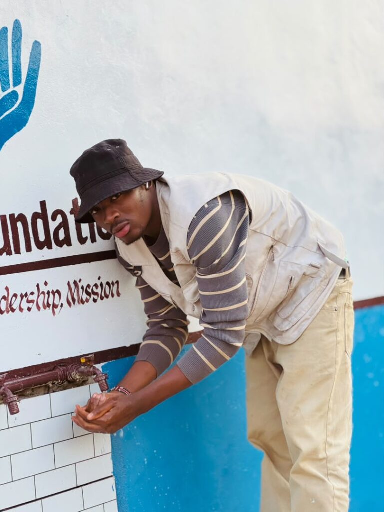 Luc Kasombwayi, Co-Founder and Program Manager, at a water collection point